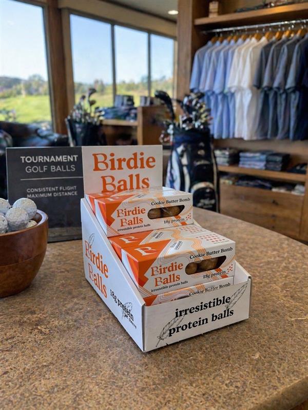 Birdie Balls display on a pro shop counter